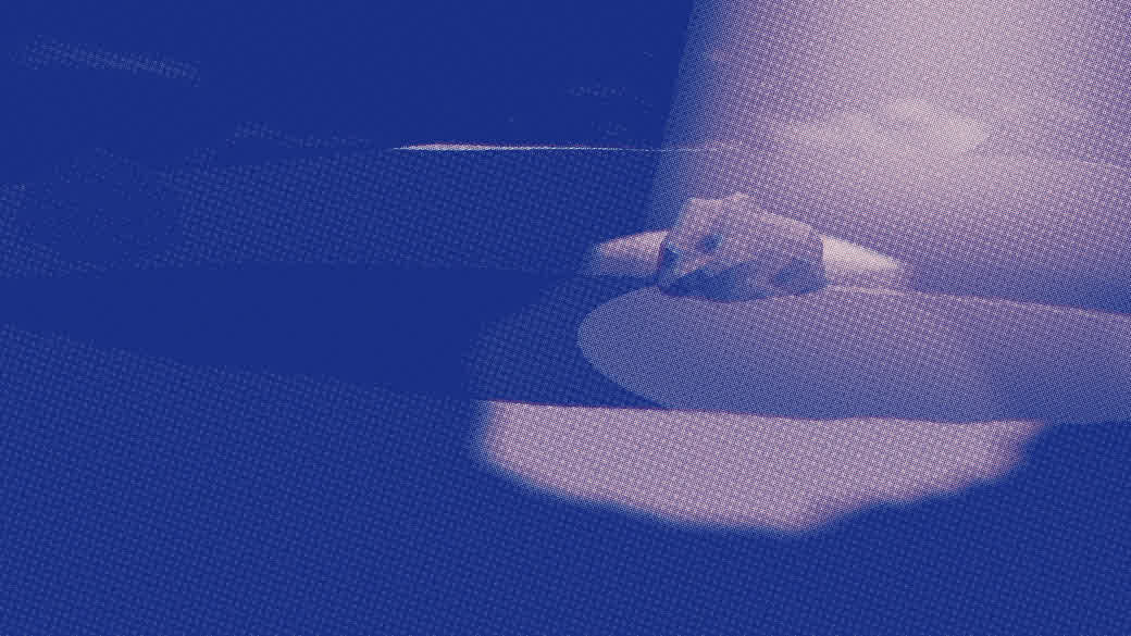 A wide cavern rendered in risograph blue: a long still pond running into the dark, its surface catching a cold light.